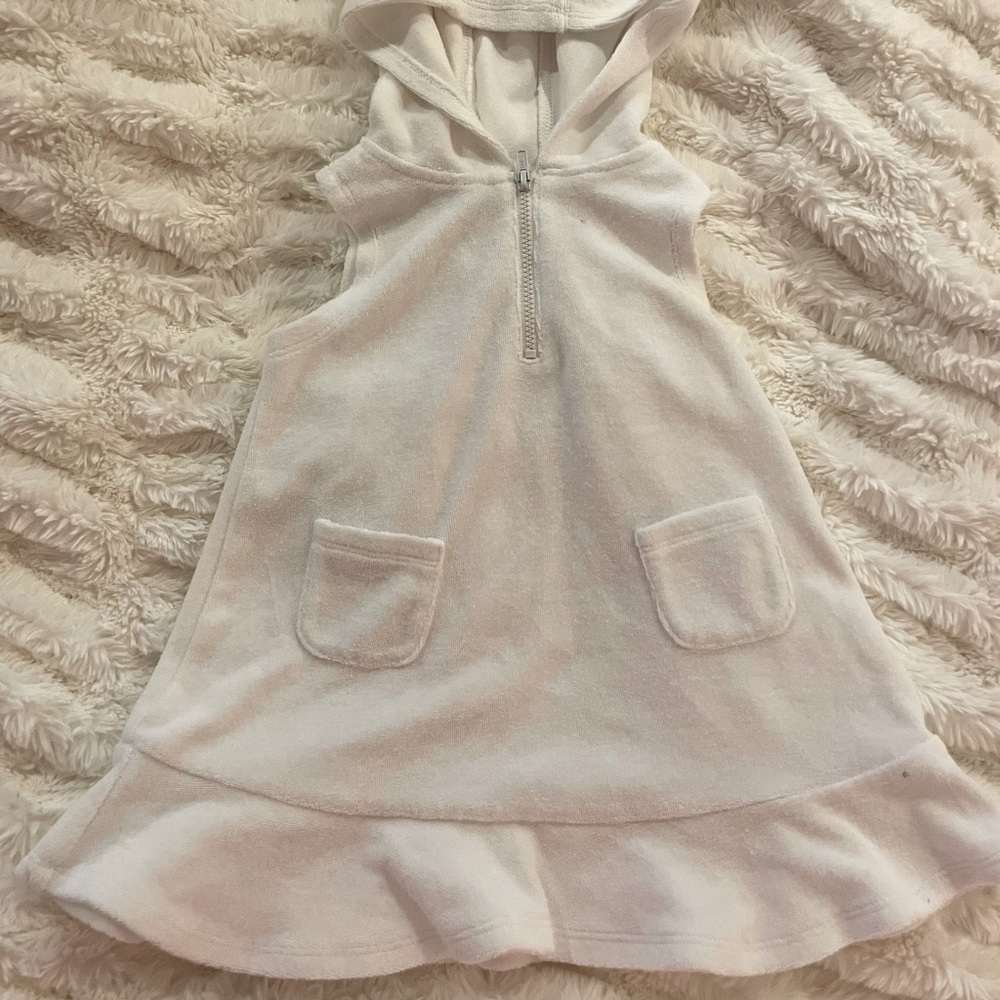 First impressions. White sleeveless terry cloth swimsuit cover-up with hood.